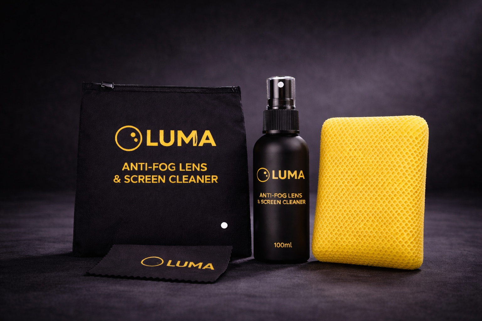 Luma anti-fog lens and screen cleaner set with spray bottle, cloth, and pouch on a dark background