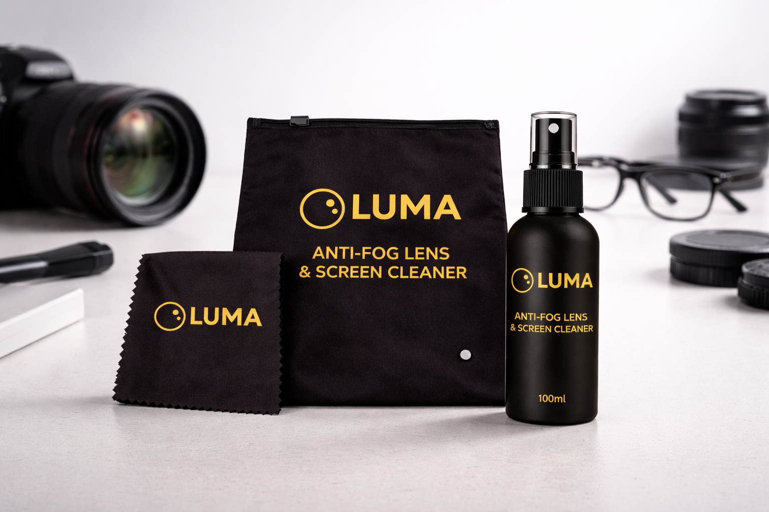 Luma anti-fog lens and screen cleaner set with spray bottle, cloth, and pouch on a white surface.